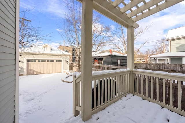 snow covered deck with a garage