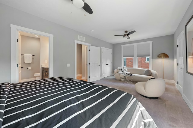 carpeted bedroom with ceiling fan, ensuite bathroom, and a closet