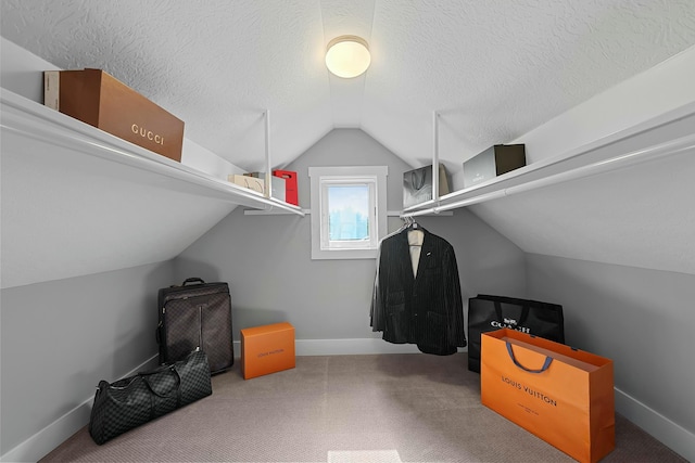 spacious closet featuring carpet floors and lofted ceiling