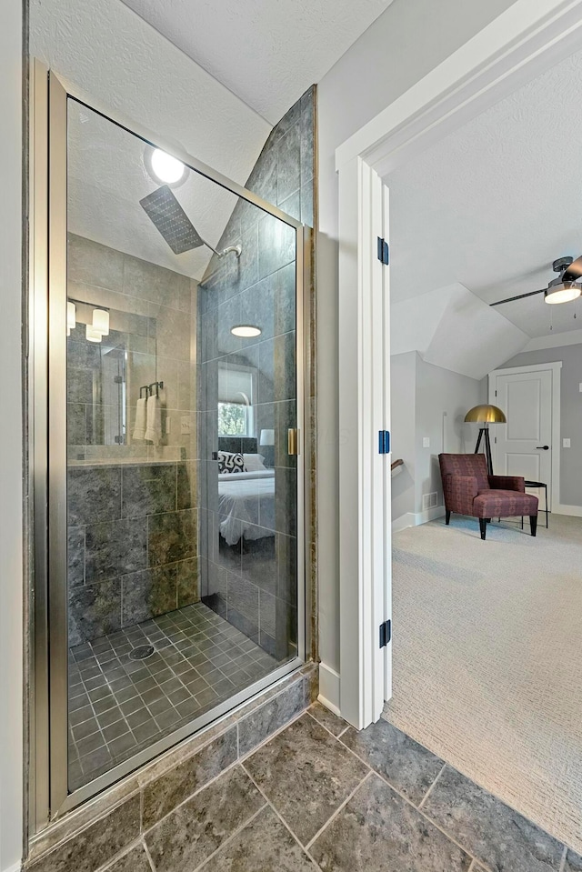 bathroom featuring a textured ceiling, an enclosed shower, and vaulted ceiling