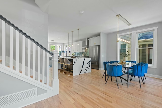 dining space featuring sink and light hardwood / wood-style flooring