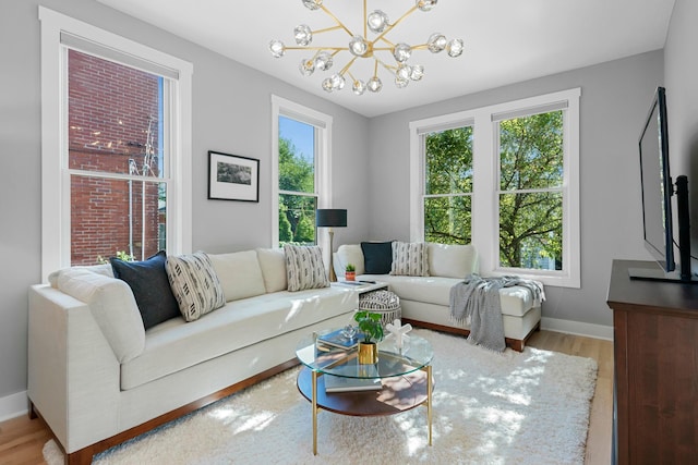 living room featuring light hardwood / wood-style floors and an inviting chandelier