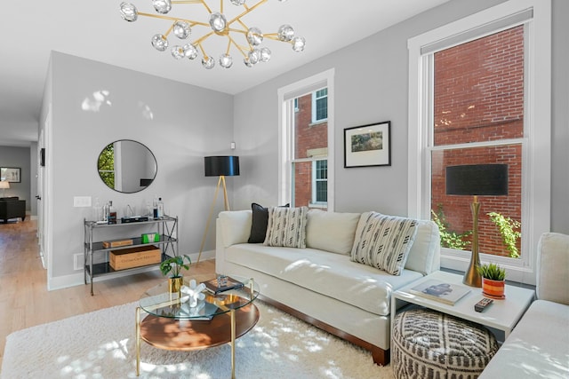 living room featuring wood-type flooring and an inviting chandelier