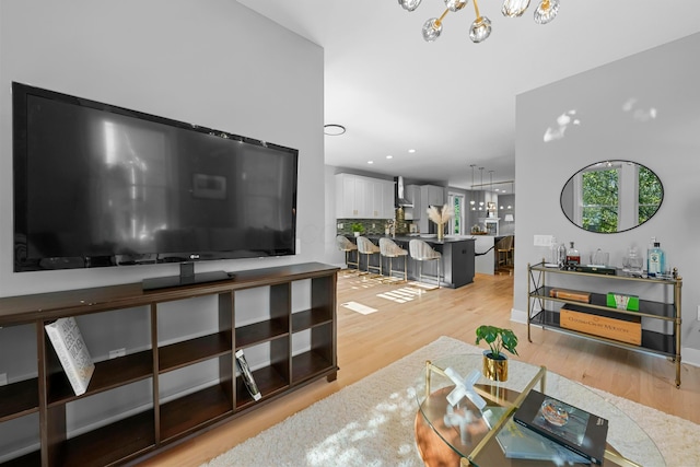 living room featuring hardwood / wood-style floors and an inviting chandelier