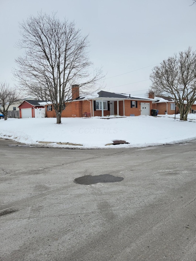 view of front of property featuring an outdoor structure and a garage