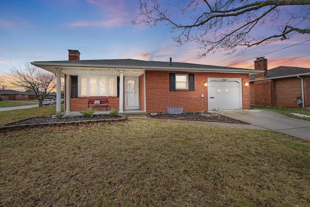 ranch-style house featuring a garage and a lawn