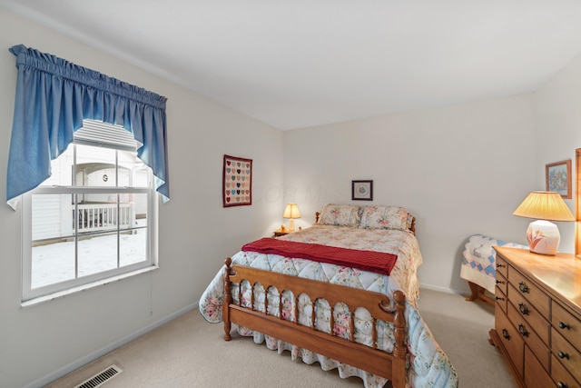 carpeted bedroom featuring baseboards and visible vents