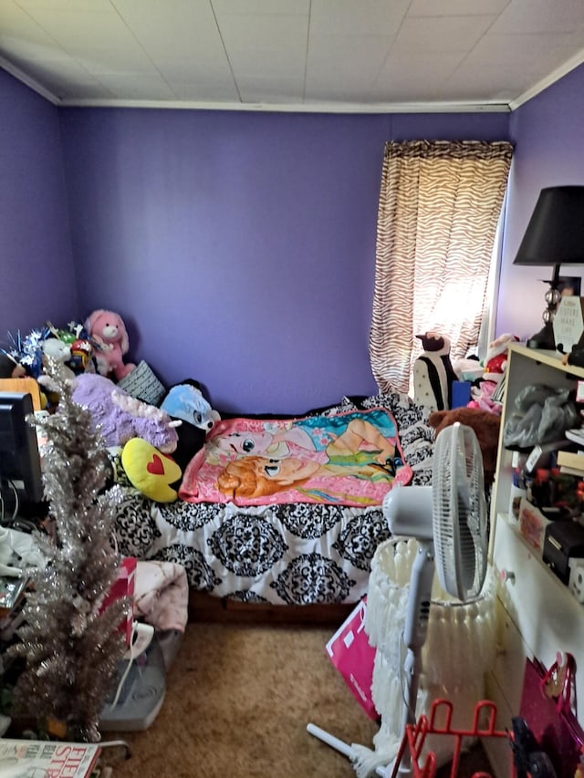 bedroom with carpet floors and crown molding