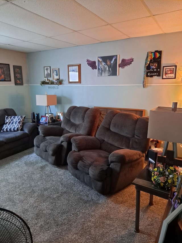 living room with a paneled ceiling and carpet flooring