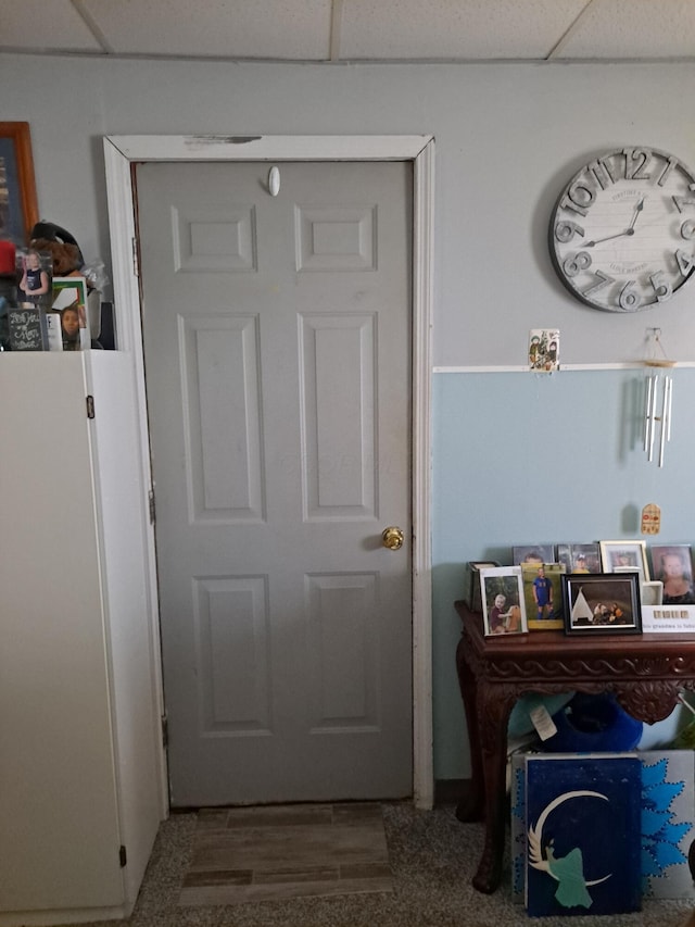 doorway to outside with a paneled ceiling