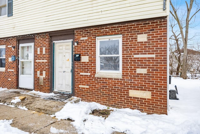 view of snow covered property entrance