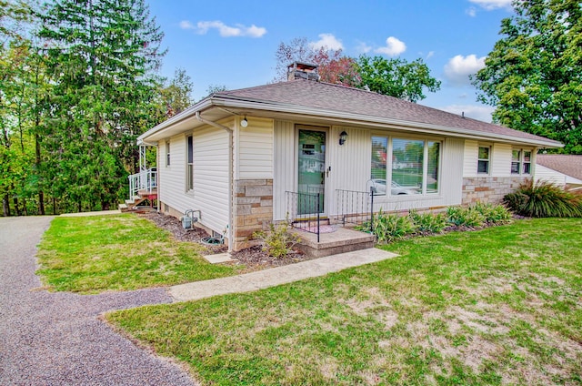 ranch-style home with a front lawn