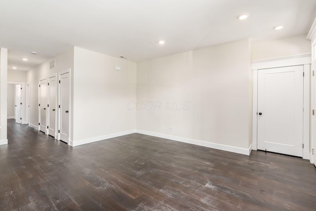 unfurnished room featuring dark wood-type flooring