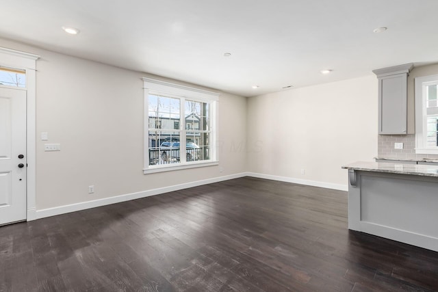 unfurnished living room with dark hardwood / wood-style flooring