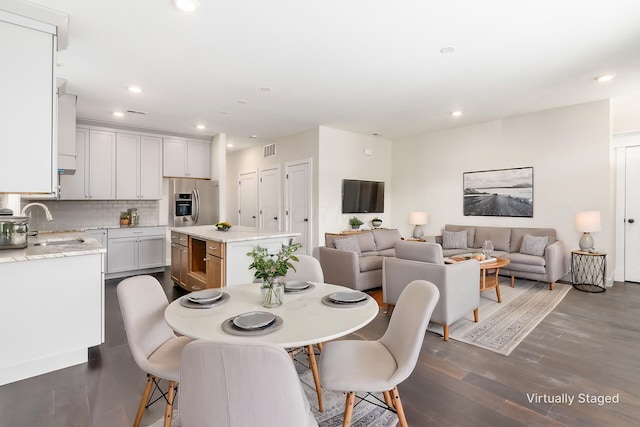 dining area featuring sink and dark hardwood / wood-style floors