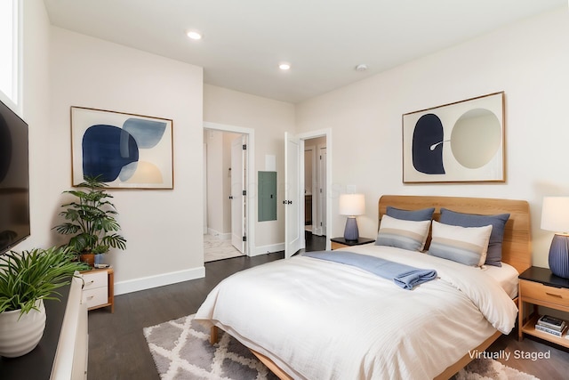 bedroom featuring electric panel and dark wood-type flooring