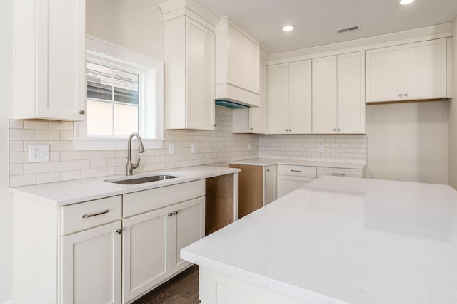 2015 W 5th Ave Unit 211, Columbus, OH 43212 - kitchen with white cabinetry, sink, and tasteful backsplash
