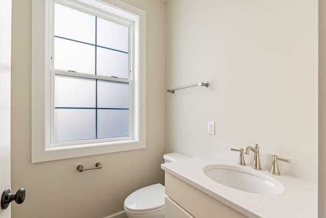 2015 W 5th Ave Unit 211, Columbus, OH 43212 - bathroom featuring plenty of natural light, toilet, and vanity