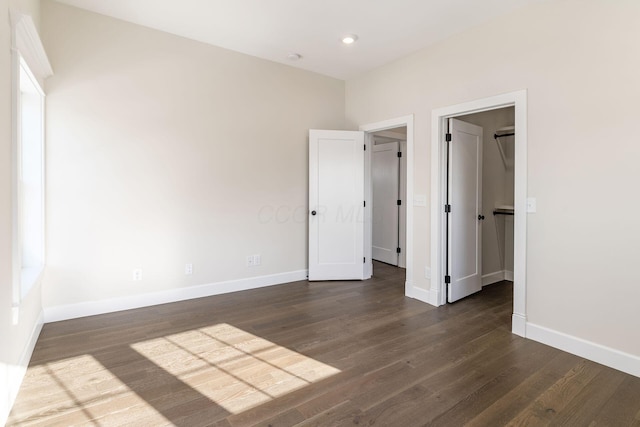 2015 W 5th Ave Unit 211, Columbus, OH 43212 - unfurnished bedroom featuring dark hardwood / wood-style floors