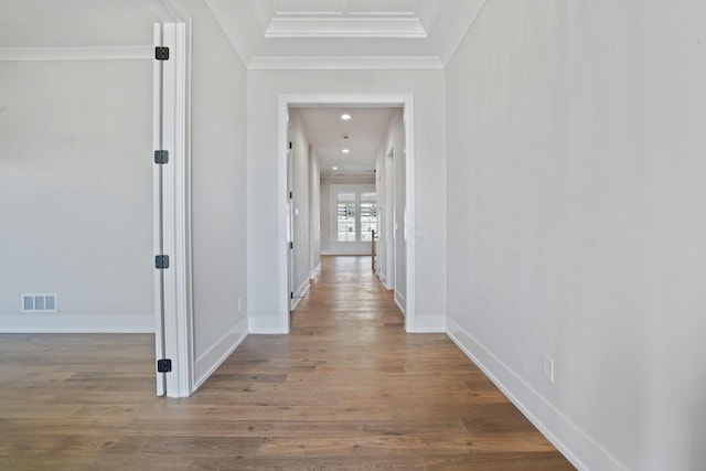 hallway featuring hardwood / wood-style flooring and ornamental molding