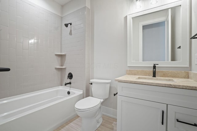 full bathroom featuring vanity, toilet, tiled shower / bath combo, and wood-type flooring