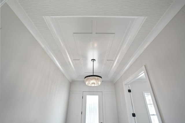 interior space featuring an inviting chandelier and ornamental molding