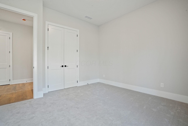 unfurnished bedroom with a closet and carpet