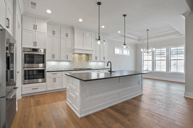 kitchen featuring white cabinetry, pendant lighting, and appliances with stainless steel finishes