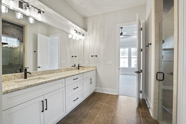 bathroom featuring ceiling fan, vanity, and an enclosed shower