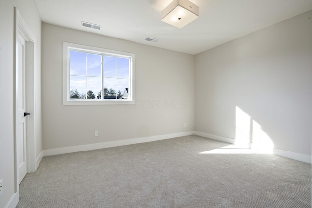 empty room featuring light colored carpet