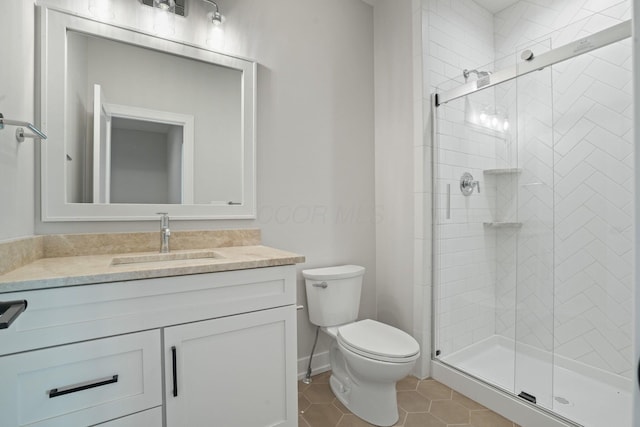 bathroom featuring vanity, tile patterned floors, toilet, and walk in shower