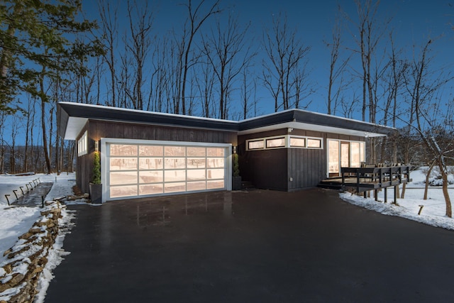 snow covered property featuring a garage