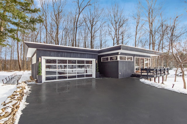 view of snowy exterior with a garage