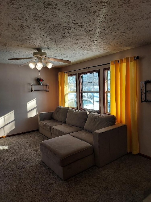 carpeted living room with ceiling fan and a textured ceiling