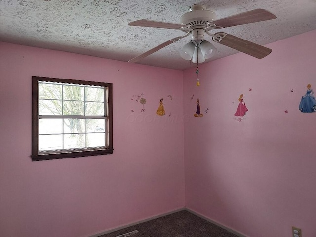 unfurnished room featuring a textured ceiling, ceiling fan, and carpet flooring