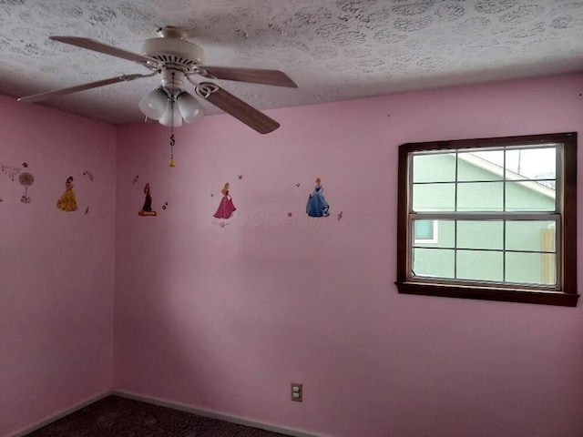 spare room with a textured ceiling, ceiling fan, and carpet floors