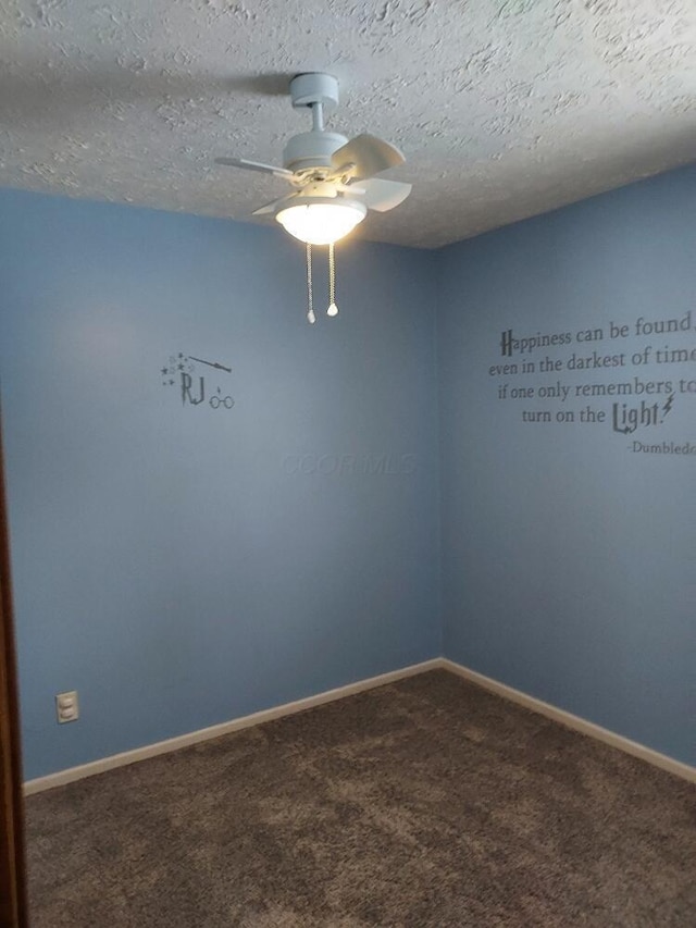 carpeted empty room featuring ceiling fan and a textured ceiling