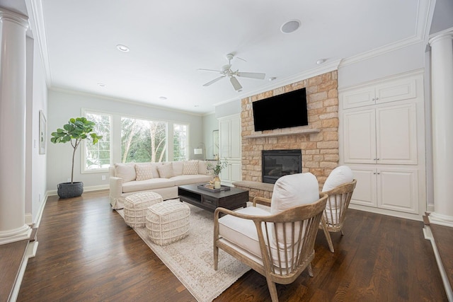 living room featuring a stone fireplace, ceiling fan, crown molding, and dark wood-type flooring