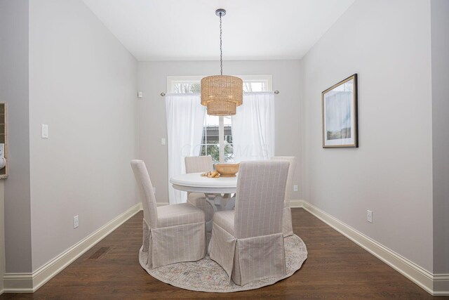 dining area featuring dark wood-type flooring