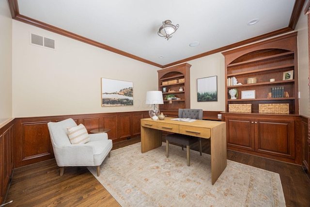 office area with crown molding, built in features, and dark wood-type flooring