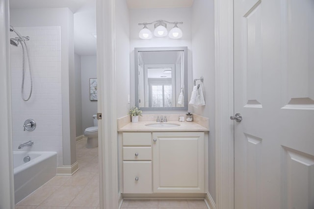 full bathroom with tile patterned flooring, vanity, toilet, and tiled shower / bath