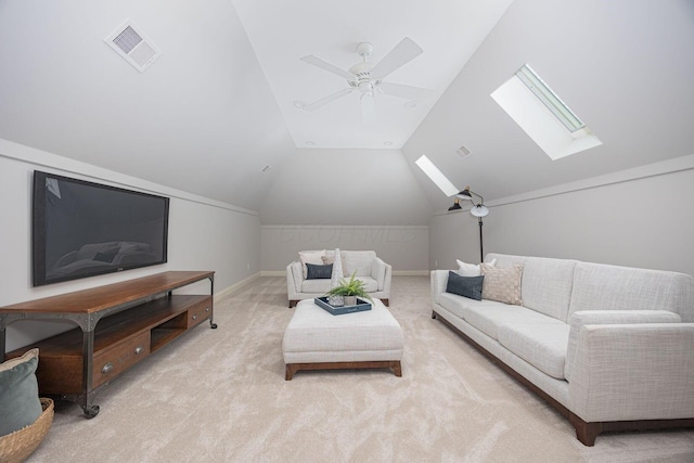 carpeted living room with lofted ceiling with skylight and ceiling fan