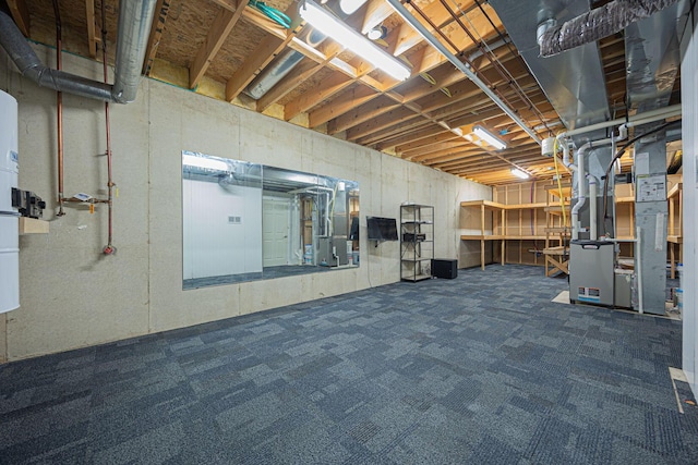 basement featuring dark colored carpet and heating unit