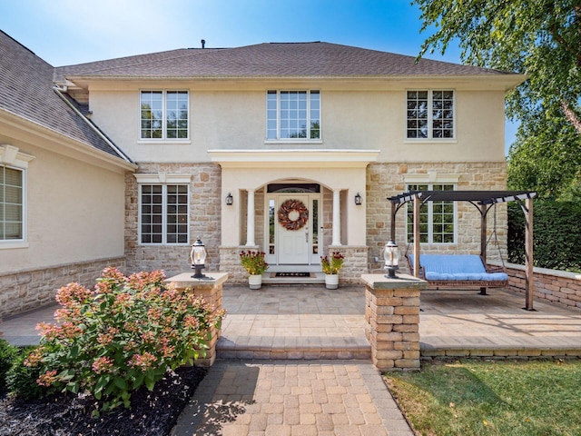 view of front of property with a pergola