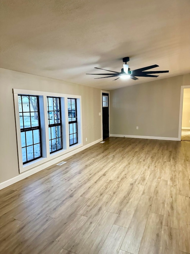 unfurnished room with light hardwood / wood-style floors and ceiling fan