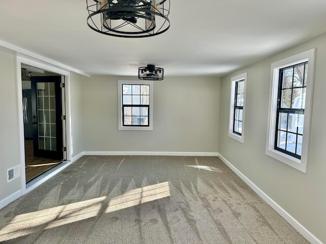 unfurnished dining area featuring carpet flooring