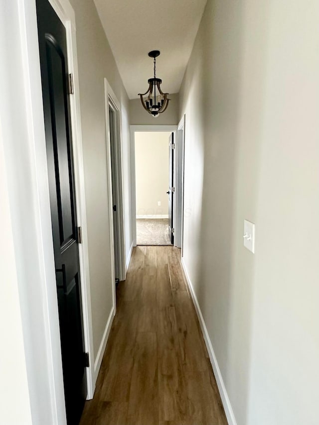 hall with a chandelier and hardwood / wood-style flooring