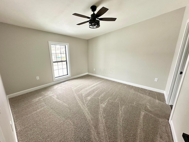 spare room with carpet floors and ceiling fan