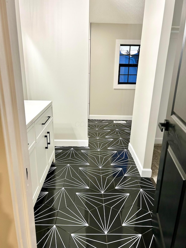 bathroom with vanity and a textured ceiling