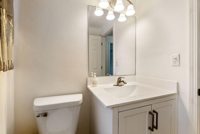 bathroom featuring toilet and vanity